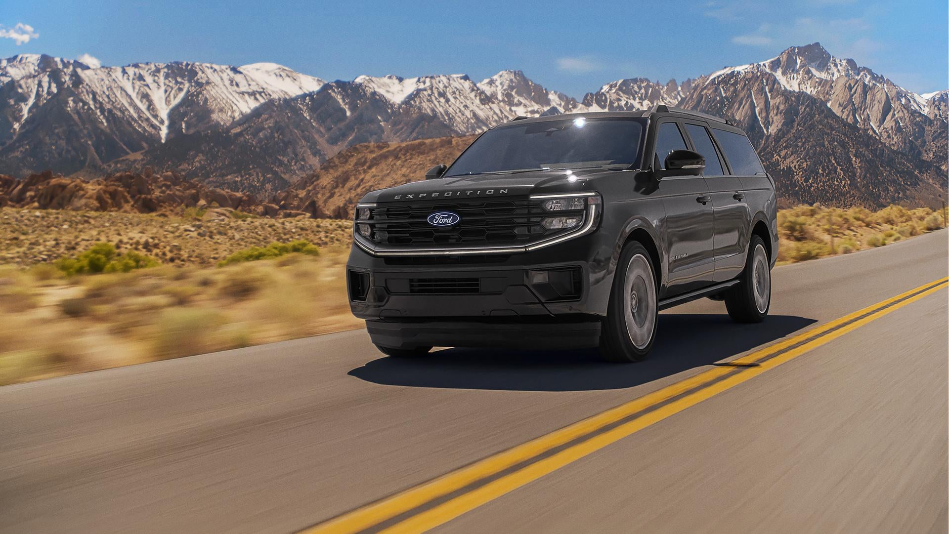2027 Ford Expedition Platinum driving on a mountain road.