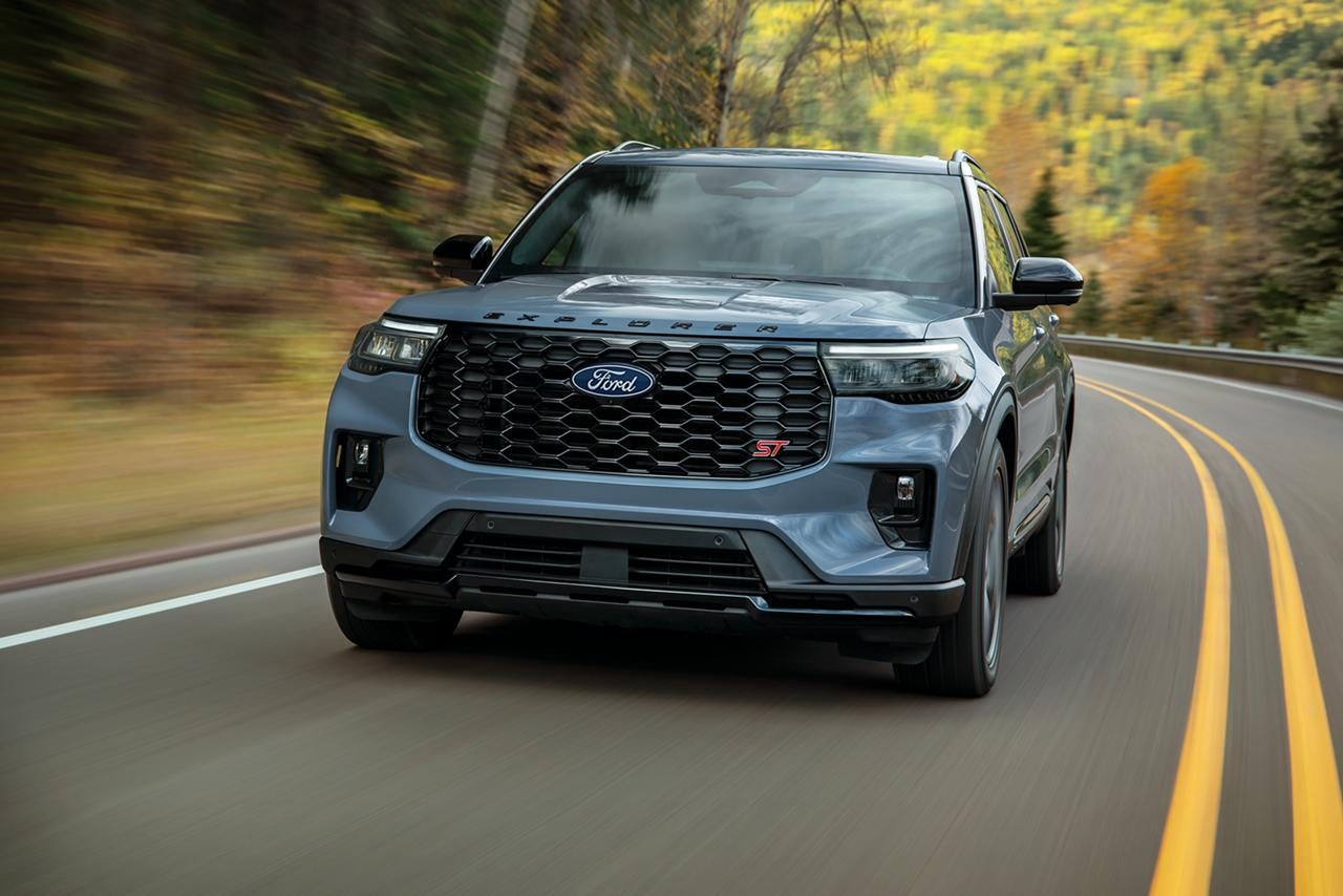 2027 Ford Explorer ST driving on a winding mountain road.